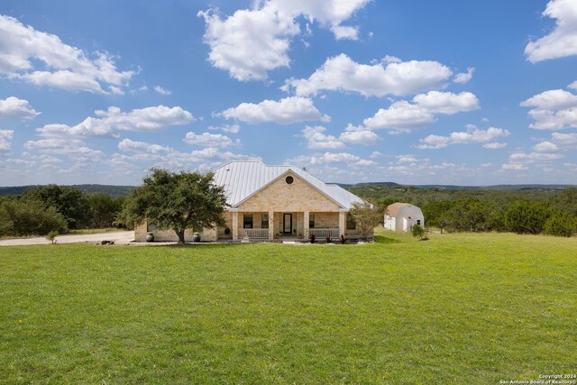 view of front of property featuring a mountain view, a garage, a front lawn, and central air condition unit