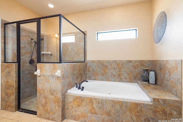 bathroom featuring independent shower and bath, a textured ceiling, and tile patterned flooring