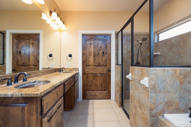 bathroom with independent shower and bath, vanity, and tile patterned floors