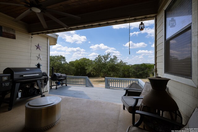 view of patio featuring a wooden deck, area for grilling, and ceiling fan