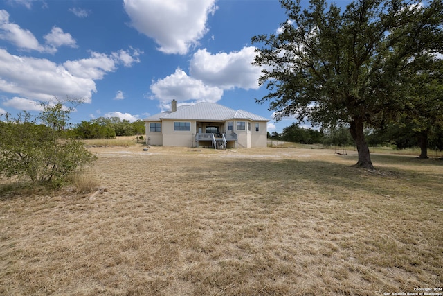 rear view of house featuring a lawn