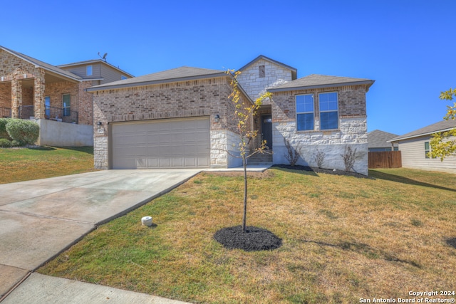 view of front of property featuring a front yard and a garage