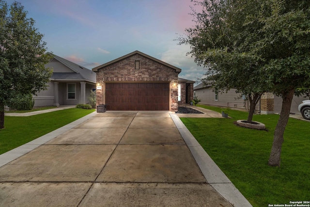 view of front of home with a lawn and a garage