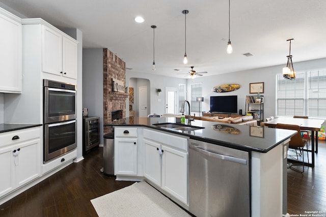 kitchen with white cabinets, stainless steel appliances, plenty of natural light, and sink