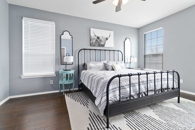 bedroom with dark hardwood / wood-style flooring and ceiling fan