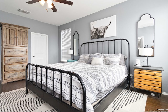 bedroom featuring ceiling fan and dark hardwood / wood-style flooring