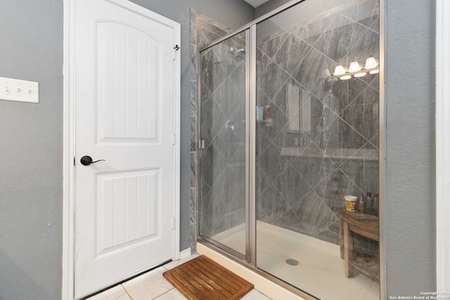 bathroom with tile patterned floors and an enclosed shower