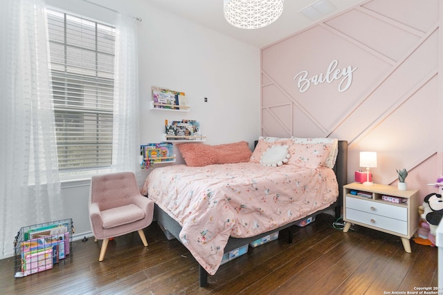 bedroom with dark hardwood / wood-style floors