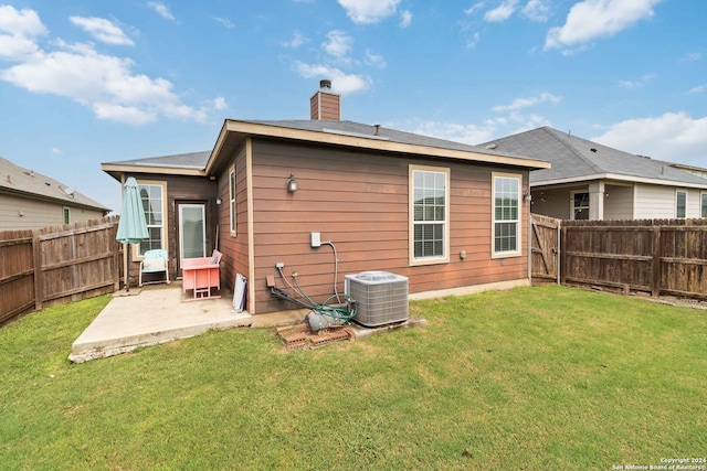 back of house featuring a patio, cooling unit, and a yard