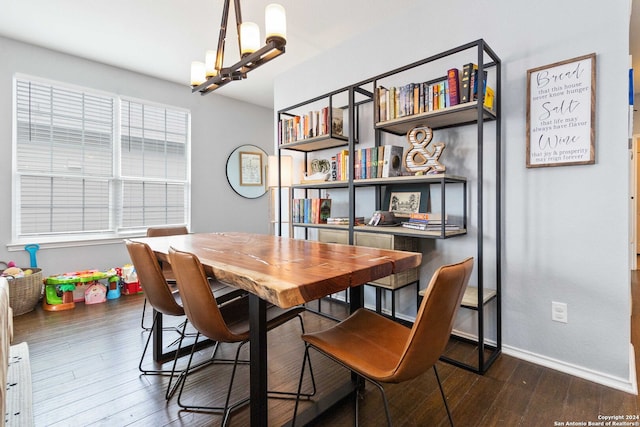 dining area featuring dark hardwood / wood-style floors and a chandelier