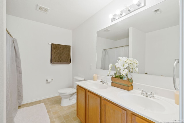 bathroom featuring vanity, toilet, and curtained shower