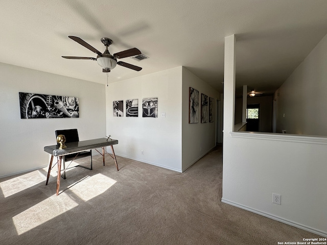 carpeted home office with ceiling fan