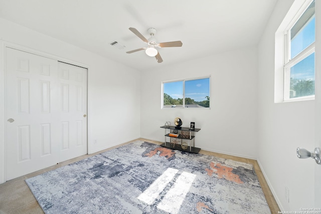 bedroom featuring ceiling fan and a closet