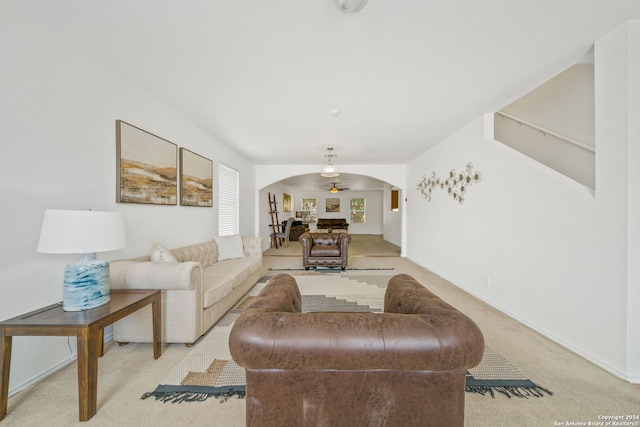 living room with ceiling fan and light colored carpet