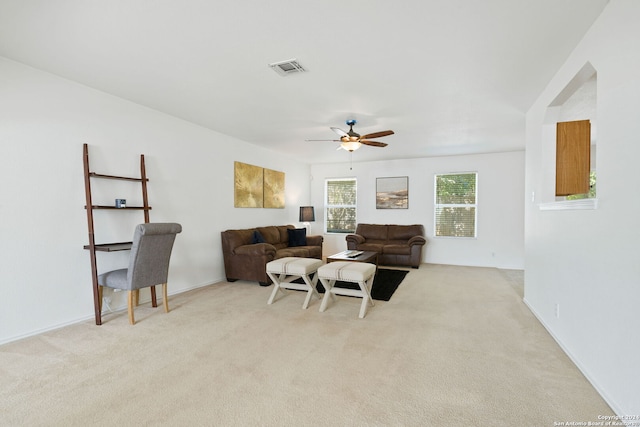 carpeted living room featuring ceiling fan