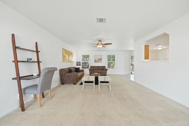 living room featuring light carpet and ceiling fan