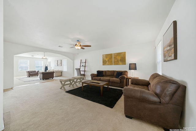 carpeted living room featuring ceiling fan