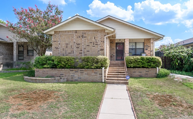 bungalow-style home featuring covered porch and a front yard