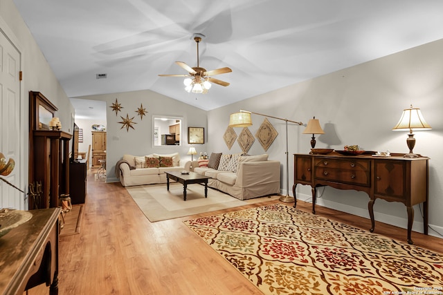 living room with lofted ceiling, light hardwood / wood-style floors, and ceiling fan