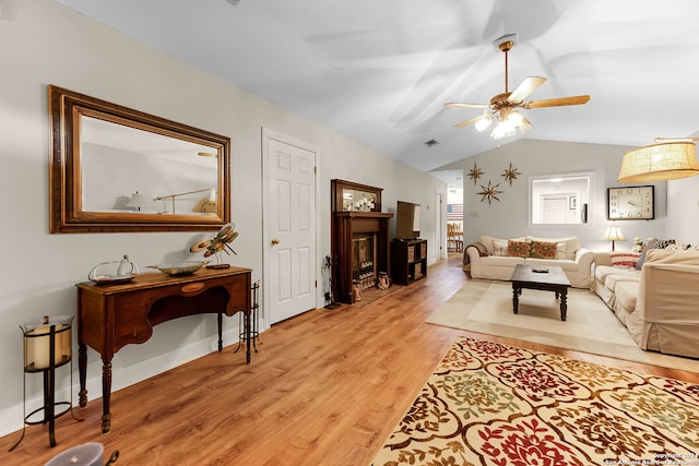 living room featuring light wood-type flooring, lofted ceiling, and ceiling fan