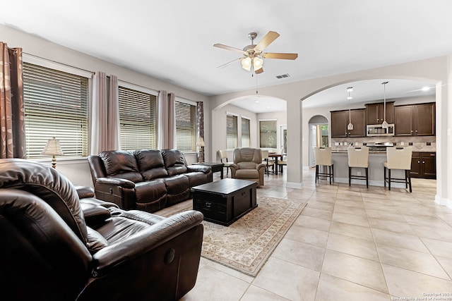 tiled living room featuring ceiling fan