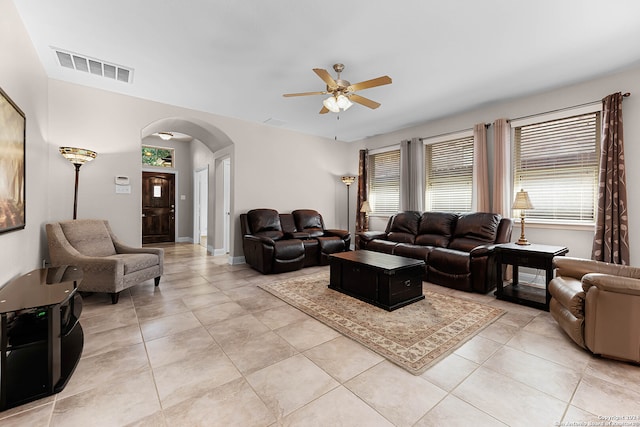 tiled living room with ceiling fan