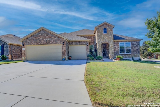 view of front facade with a front yard and a garage