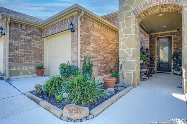 view of exterior entry with a garage