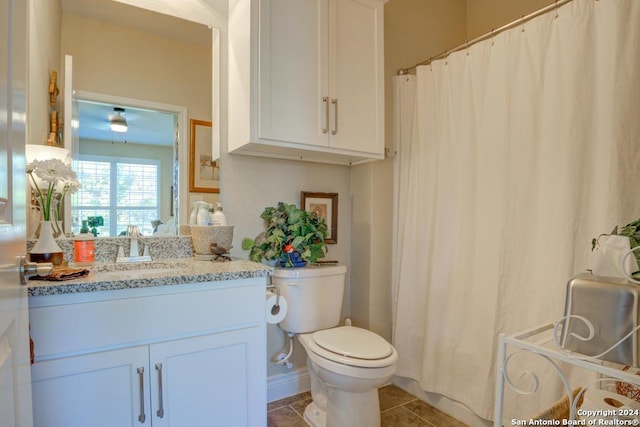 bathroom featuring a shower with curtain, vanity, toilet, and tile patterned floors