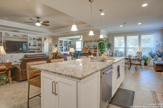 kitchen featuring decorative light fixtures, dishwasher, light stone counters, and white cabinets