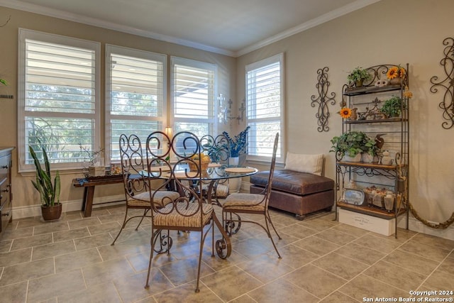 tiled dining room featuring crown molding