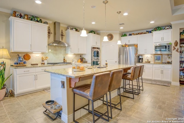 12624 Horseshoe Bay, San Antonio, TX 78253 - kitchen featuring crown molding, wall chimney exhaust hood, white cabinets, appliances with stainless steel finishes, and a breakfast bar area