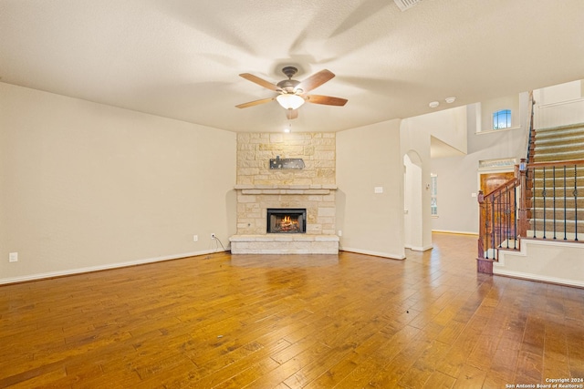 11806 Jasmine Way, San Antonio, TX 78253 - unfurnished living room with stairs, a ceiling fan, hardwood / wood-style flooring, and a fireplace