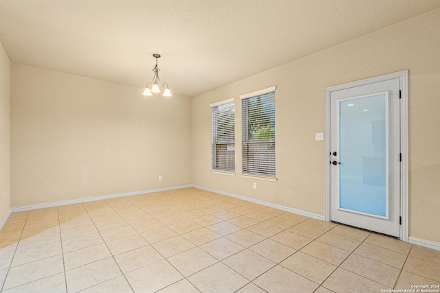 11806 Jasmine Way, San Antonio, TX 78253 - empty room with an inviting chandelier, baseboards, and light tile patterned flooring