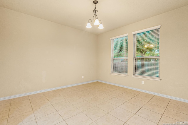 11806 Jasmine Way, San Antonio, TX 78253 - empty room featuring baseboards, light tile patterned floors, and a notable chandelier