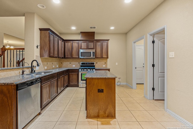 11806 Jasmine Way, San Antonio, TX 78253 - kitchen with a sink, stone countertops, stainless steel appliances, tasteful backsplash, and a kitchen island