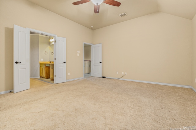 unfurnished bedroom featuring light carpet, lofted ceiling, and ceiling fan