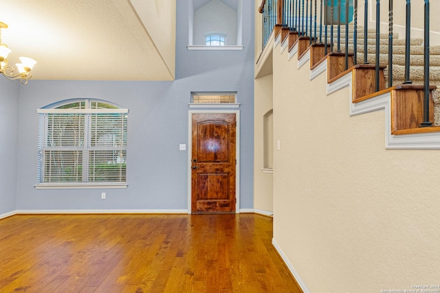 11806 Jasmine Way, San Antonio, TX 78253 - foyer entrance featuring a high ceiling, an inviting chandelier, stairs, baseboards, and wood finished floors