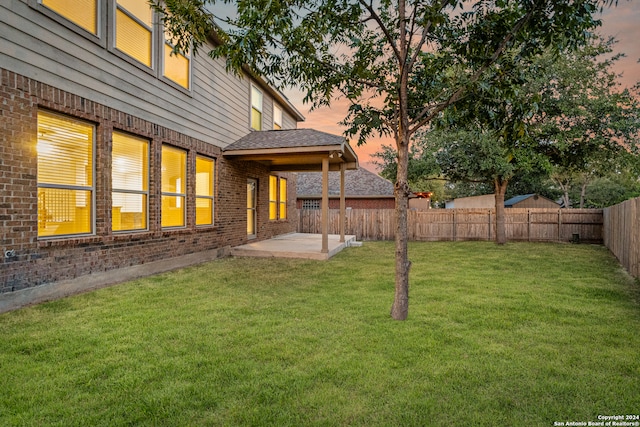 yard at dusk with a patio