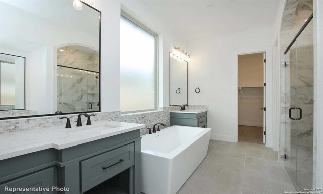 bathroom with tasteful backsplash, plus walk in shower, and vanity