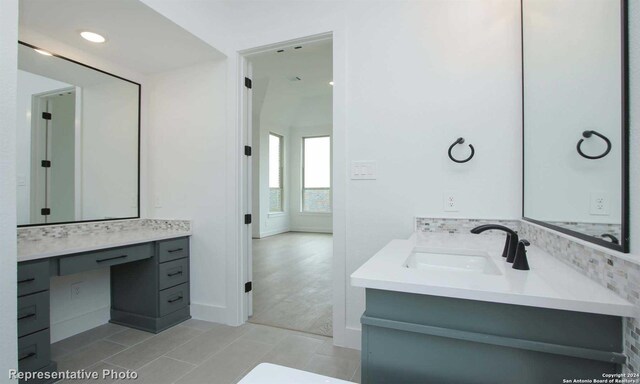 bathroom with vanity and decorative backsplash