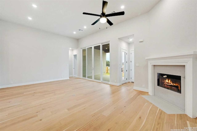 unfurnished living room with light hardwood / wood-style flooring and ceiling fan