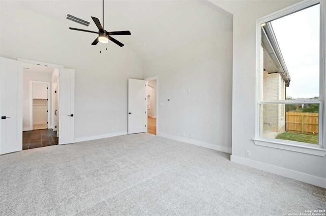 interior space with high vaulted ceiling, ceiling fan, and dark colored carpet