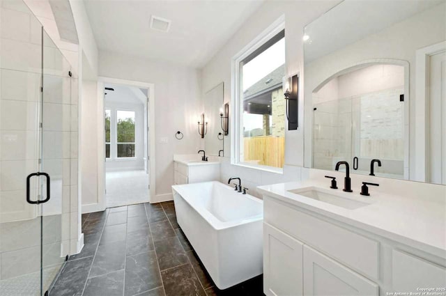 bathroom with vanity and separate shower and tub