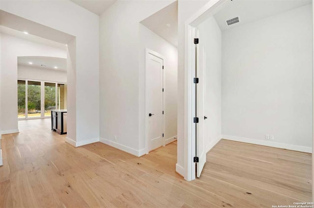 corridor with light hardwood / wood-style flooring