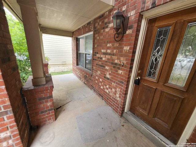 view of exterior entry featuring a porch