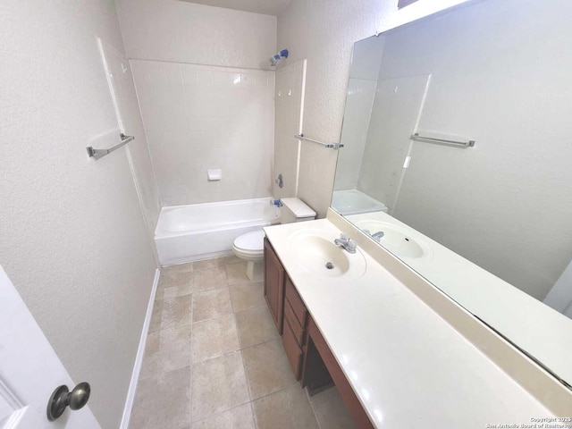 bathroom featuring tile patterned flooring, bathing tub / shower combination, toilet, a textured wall, and vanity