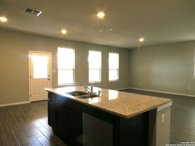 kitchen featuring a center island with sink, dark hardwood / wood-style floors, a healthy amount of sunlight, and stainless steel dishwasher