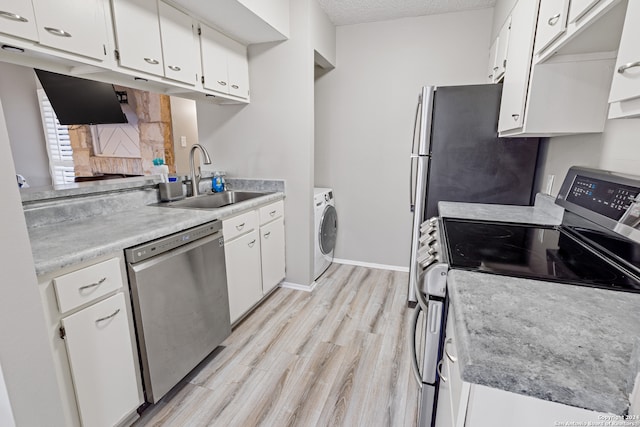 kitchen featuring white cabinets, sink, a textured ceiling, appliances with stainless steel finishes, and light wood-type flooring