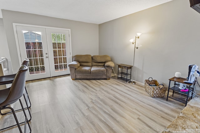 living room featuring french doors and light hardwood / wood-style floors